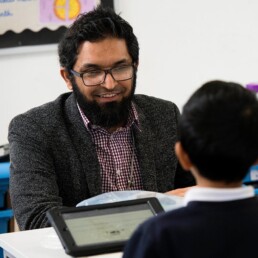 Teacher and boy using iPad