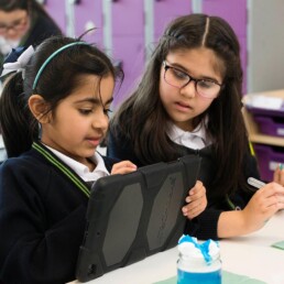 Two girls working on iPad