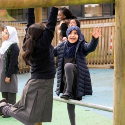 Girls using climbing frame