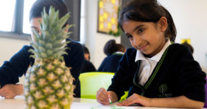 Girl drawing a pineapple